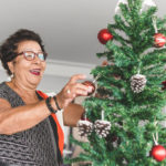 elderly-man-opening-present / grandma-decorating-christmas-tre